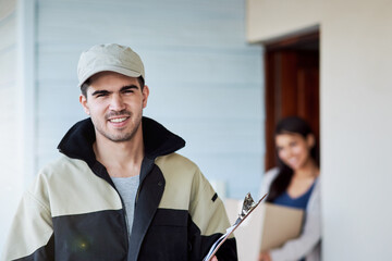 He always delivers. Portrait of a courier making a home delivery to a customer.