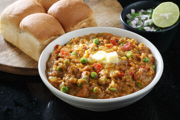 Mumbai Style Pav bhaji is a fast food dish from India, consists of a thick vegetable curry served with a soft bread roll