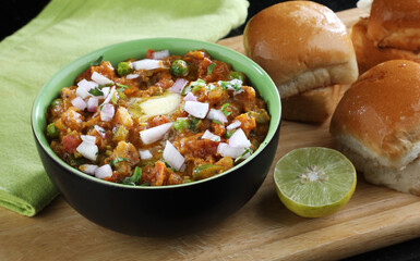 Mumbai Style Pav bhaji is a fast food dish from India, consists of a thick vegetable curry served with a soft bread roll