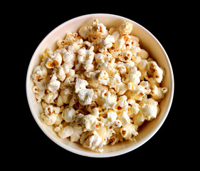 bowl of popcorn isolated, popcorn in a bowl on black background.