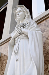 Close-up of Statue of Our lady of grace virgin Mary located in front of the church with natural background, Thailand. selective focus.