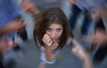 Surrounded by self-doubt. Conceptual shot of an anxious young woman in the middle of a circle of...