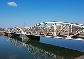 Steel bridge over the water, over Jiu. Ferdinand Bridge in Targu Jiu.