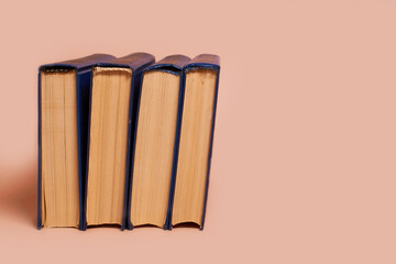 A stack of books on a colored background. Copy space