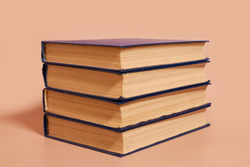 A stack of books on a colored background. Copy space