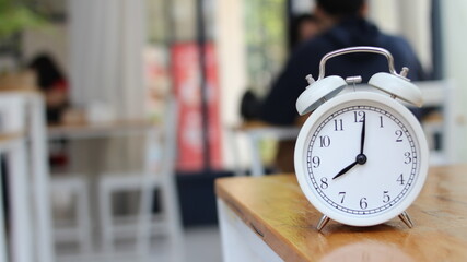 Alarm clock on the desk in the morning