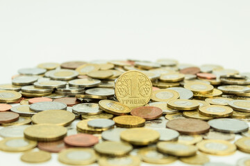 Pile of coins of different denominations on a white background