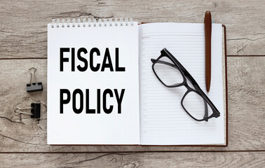 open notepad with text near calculator. fiscal policy