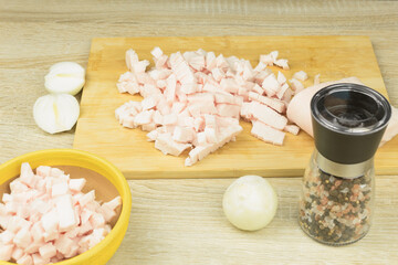 Fresh and raw lard finely chopped, meat on a cutting board