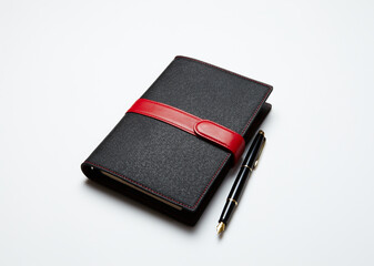 Schedule book and fountain pen on a white background.
