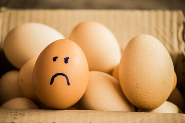 A number of eggs are filled with a pen with a facial expression.