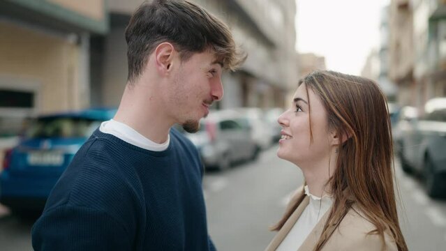 Young couple smiling confident speaking at street