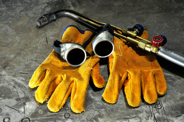 Protective goggles and gas welding machine. Welding equipment.