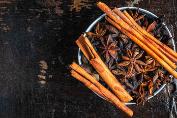 Cinnamon spices and anise stars in a bowl on the table
