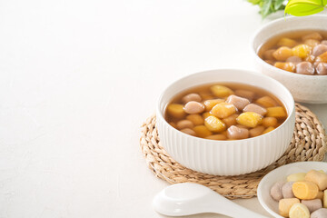 Delicious sweet taro ball soup in a white bowl for serving.