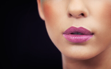 Fototapeta premium Sensual lips with striking colors. Cropped shot of a woman wearing colorful cosmetics.