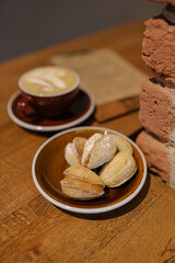 Coffee in hands cappuccino with creams 