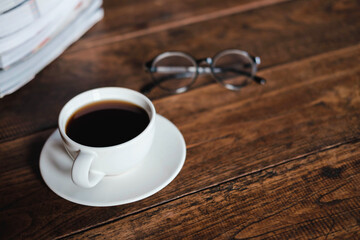 Coffee cups and books placed on old wooden tables