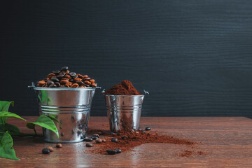 .Roasted coffee beans and coffee powder on a wooden table