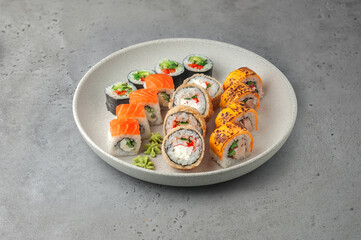 sushi set with maki rolls on gray background