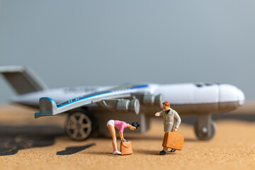 Miniature people Traveler walking to airplane on world map , Travel around the world concept.