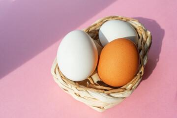 White and brown eggs in a wicker basket