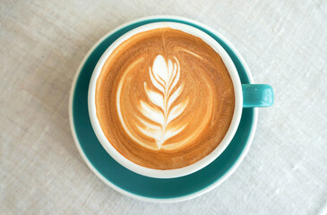 Hot cappuccino coffee in a blue mug
