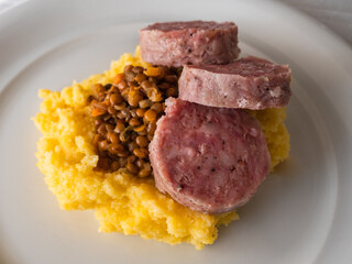 Cotechino, a large Italian Pork Sausage with Lentils and Polenta, a traditional New Year's Eve Dinner in Italy