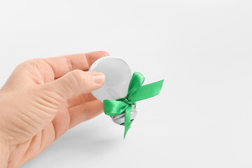 Green energy light bulb in the hand isolated