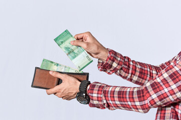 Man taking money out of his wallet, close up of hands taking money out of his wallet isolated, Nicaraguan banknotes, cash payment concept