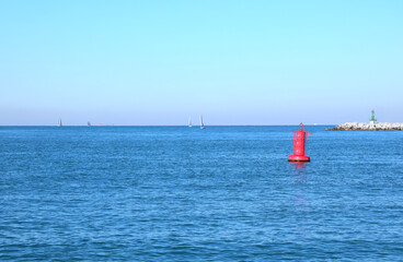Fototapeta premium red buoy in the middle of the sea to indicate the presence of the dam on boats near the island of Venice in Italy