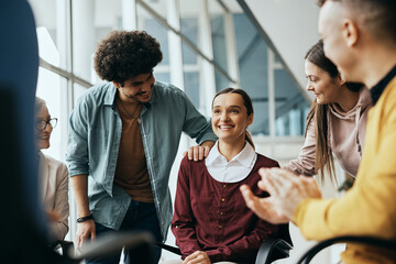 Young happy woman receives support from attenders of group therapy at mental health center. - Powered by Adobe