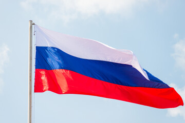 Fototapeta na wymiar Russia flag is waving in front of blue sky