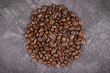 Heap of roasted coffee grains. Structure concrete