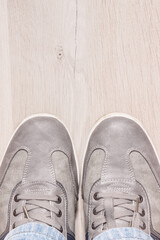 Comfortable gray leather shoes on board, male footwear, place for text