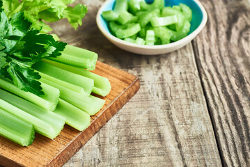 Fresh organic celery. Fresh celery on wooden table closeup.