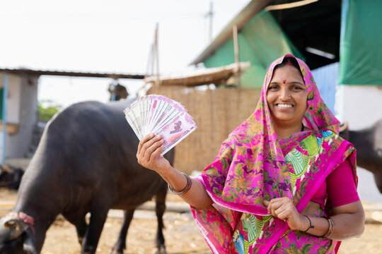 Focus On Currency Notes, Smiling Milk Dairy Village Women Showing Indian Money By Looking At Camera - Concept Of Business Profit, Banking And Agricultural.