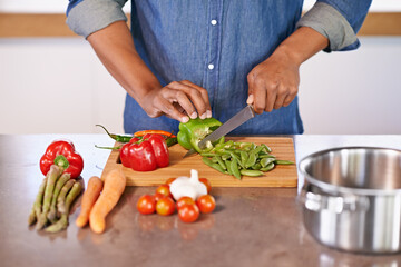 The makings of a healthy meal. Cropped view of a man chopping some fresh vegetables on the kitchen counter.