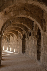 Fototapeta na wymiar Light and shadow in ancient building with many arches in it
