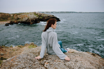 Fototapeta na wymiar woman sweaters cloudy sea admiring nature Lifestyle