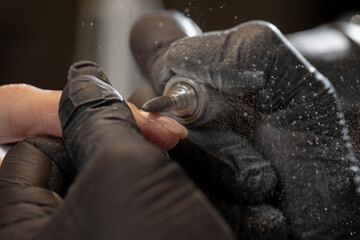 Washed down the nail plate before applying gel coatings. The work of a manicure master 
