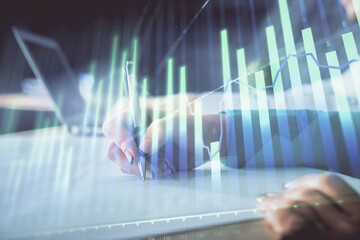 Double exposure of forex chart drawing over people taking notes background. Concept of financial analysis