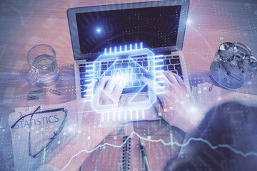 Double exposure of man's hands typing over computer keyboard and data theme hologram drawing. Top...