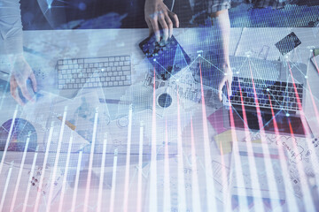 Multi exposure of man and woman working together and financial chart hologram. Business concept. Computer background.