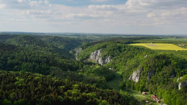 Ojcowski National Park, spring drone aerial view of Ojcow village and rocks in Pradnik Valley near Krakow (Cracow) taken in May. Okopy Mountain, Koronna Mountain Wapiennik and Puchacz Rock.