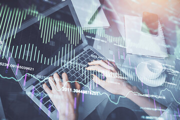 Double exposure of woman hands typing on computer and forex chart hologram drawing. Stock market invest concept.