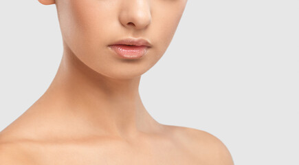 Lips and face of a young woman close-up. Cosmetic care for face and lips.