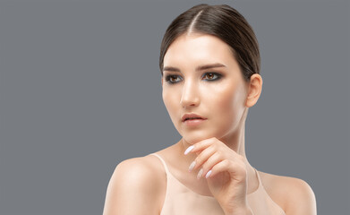 Portrait of attractive girl with healthy clean skin and beautiful make-up. Aesthetic cosmetology and makeup concept.