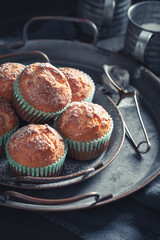 Sweet and tasty yoghurt cupcake on rustic table.