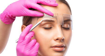 Make-up artist makes markings with white pencil for eyebrow and paints eyebrows. Professional...
